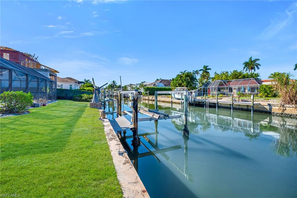 2170 Snook Drive Naples, FL 34102 - Photo 8 of 18 a view of a lake with a house in the background