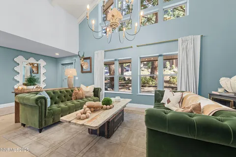 a living room with furniture ceiling fan and a window