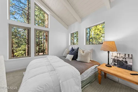 a bedroom with furniture and a flat screen tv
