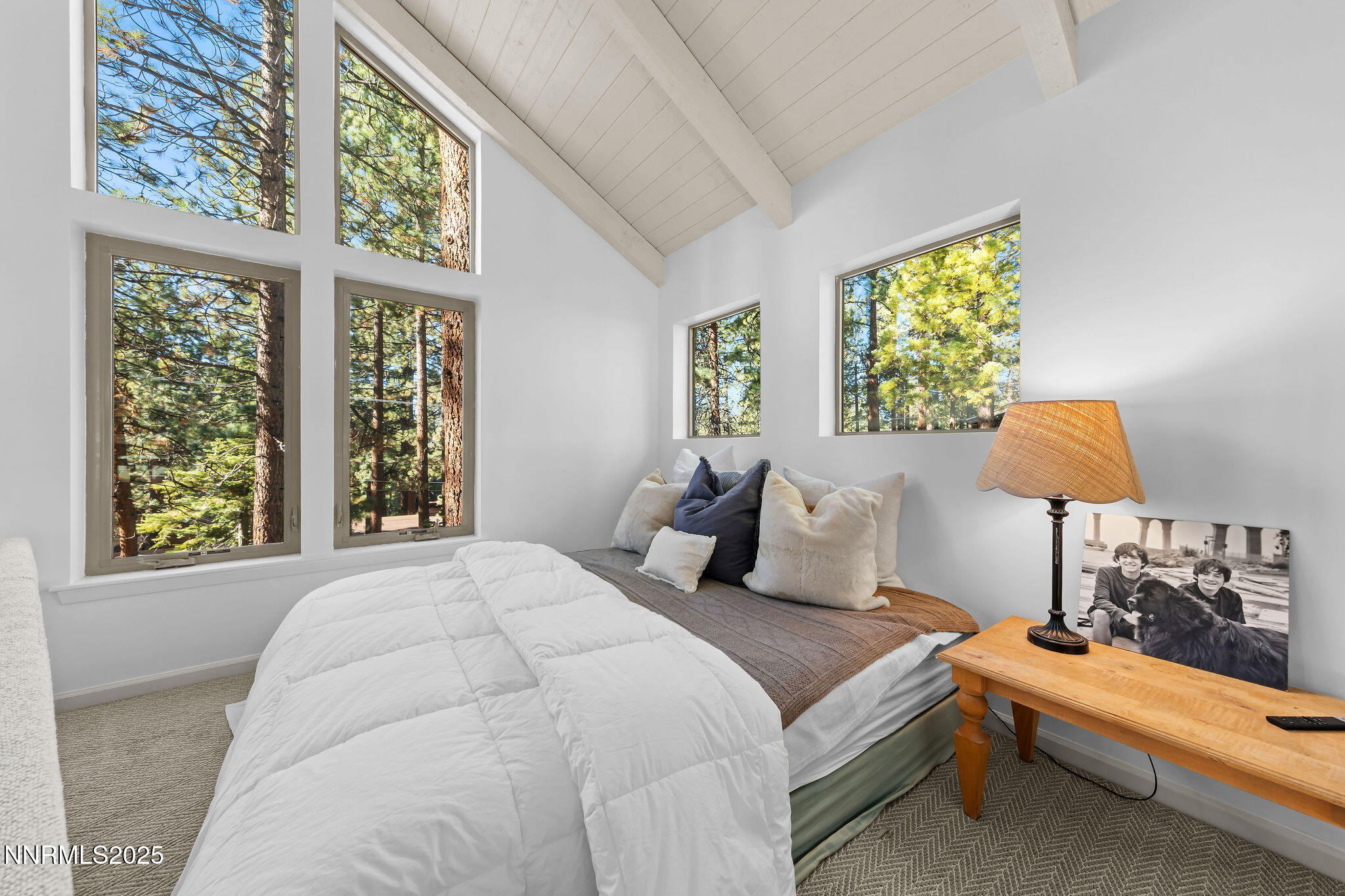 174 Hall Court Stateline, NV 89449 - Photo 21 of 40 a bedroom with a bed and a lamp next to a window