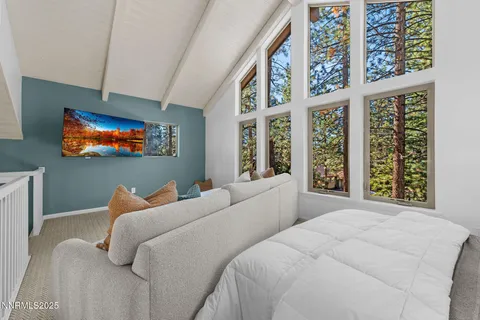 a bedroom with a large bed and a window