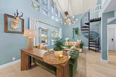 a living room with furniture and a chandelier