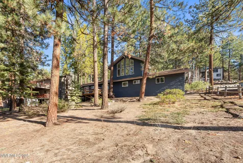 a view of a house with a yard covered in snow