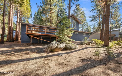 a view of a house with a tree in front of it
