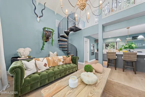 a living room with furniture flowers and a chandelier