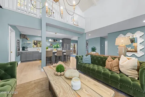 a living room with furniture and a chandelier