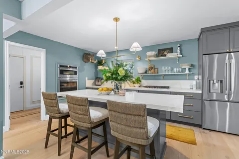 a dining room with furniture and a kitchen view