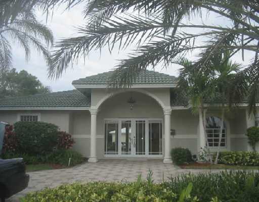 832 Coventry Street Boca Raton, FL 33487 - Photo 1 of 8 a front view of a house with a garden