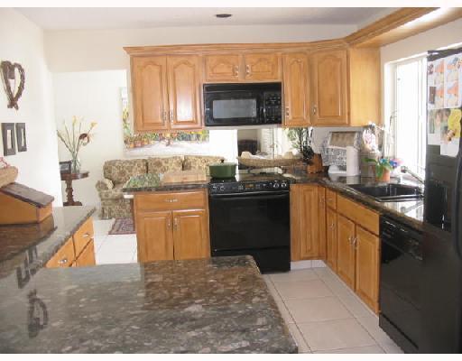832 Coventry Street Boca Raton, FL 33487 - Photo 4 of 8 a kitchen with stainless steel appliances granite countertop a stove sink and cabinets