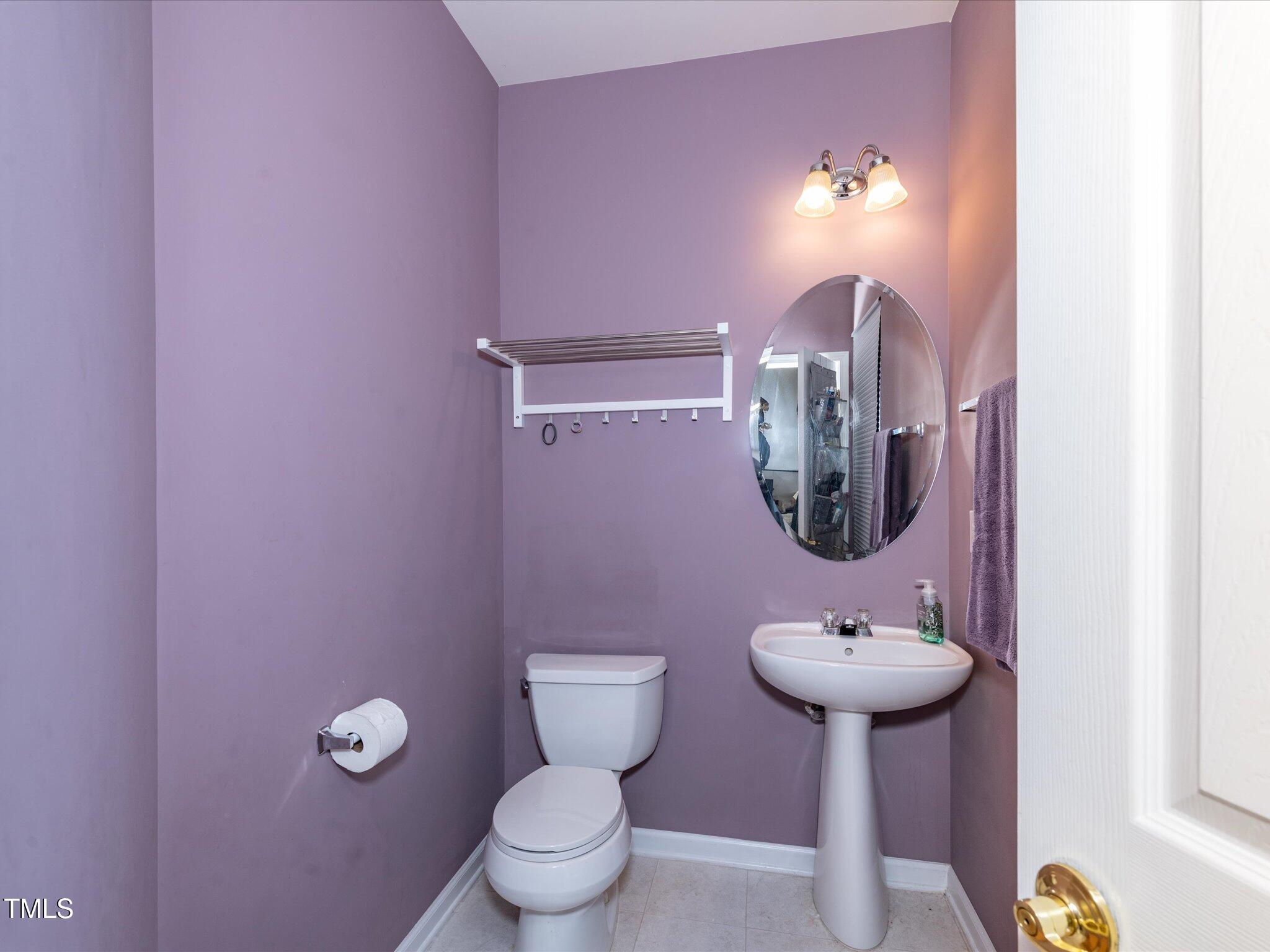 216 Ruby Walk Drive Morrisville, NC 27560 - Photo 17 of 28 a bathroom with a toilet sink and mirror