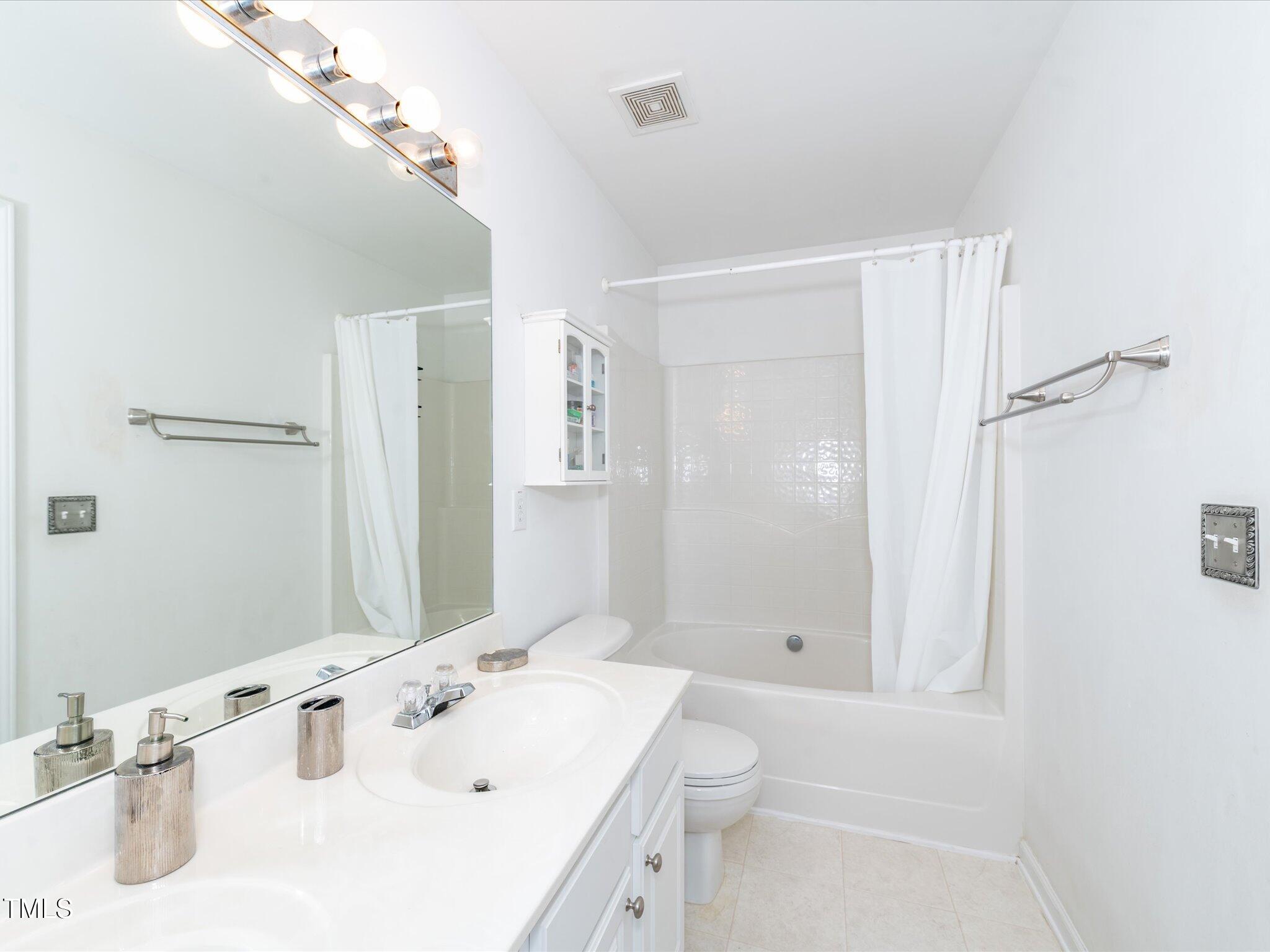 216 Ruby Walk Drive Morrisville, NC 27560 - Photo 20 of 28 a bathroom with a sink a toilet and shower