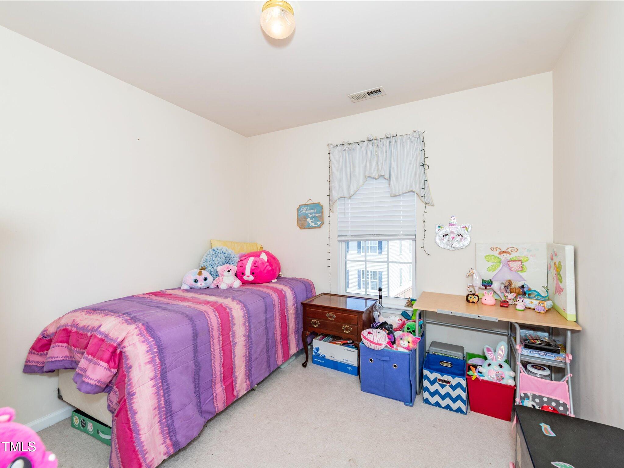 216 Ruby Walk Drive Morrisville, NC 27560 - Photo 22 of 28 a bedroom with a bed and a window