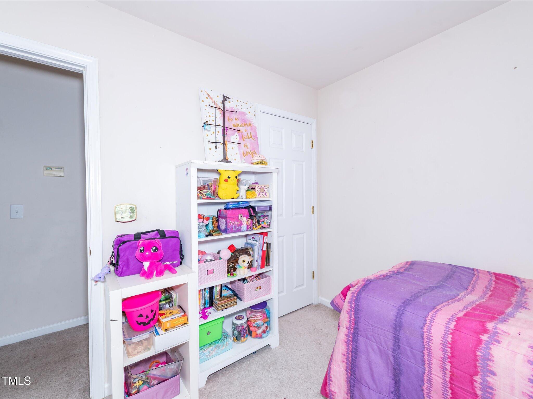 216 Ruby Walk Drive Morrisville, NC 27560 - Photo 23 of 28 a bedroom with bed and a window