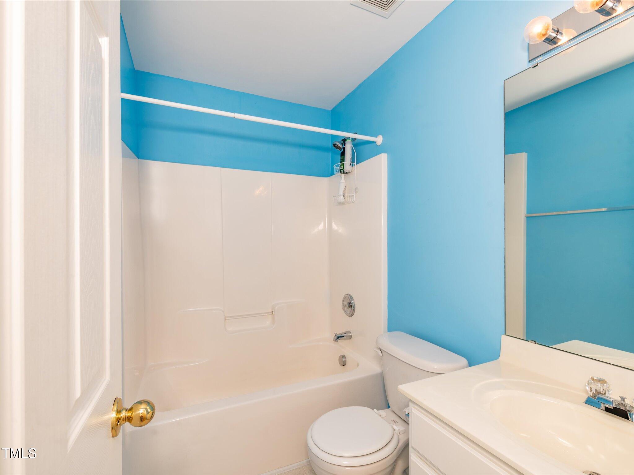 216 Ruby Walk Drive Morrisville, NC 27560 - Photo 24 of 28 a bathroom with a sink a toilet a bathtub and shower