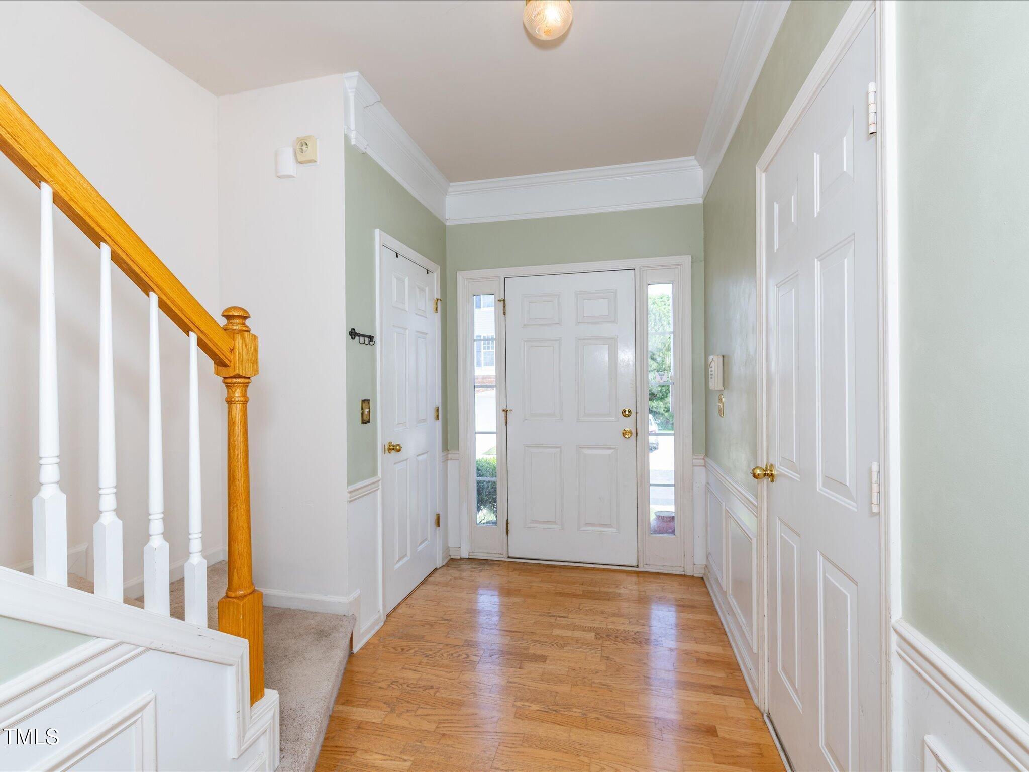 216 Ruby Walk Drive Morrisville, NC 27560 - Photo 3 of 28 a view of a hallway with wooden floor and staircase