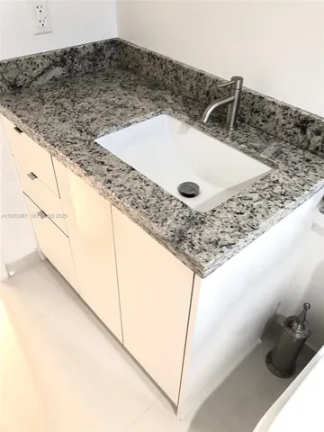 a spacious bedroom with a large bed and a large window