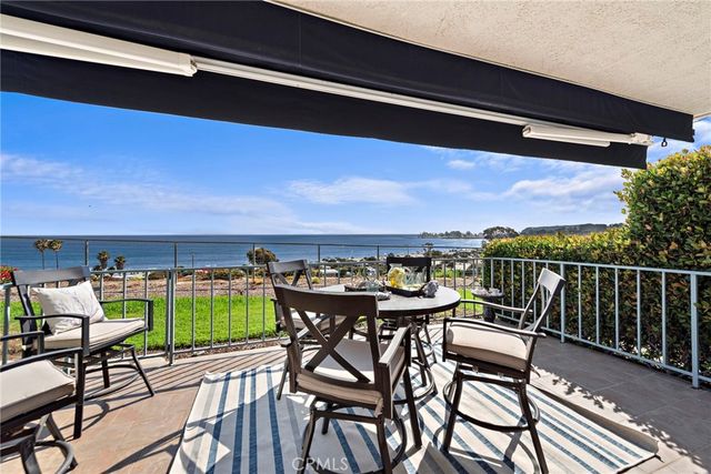 a bathroom with a granite countertop sink mirror vanity and toilet
