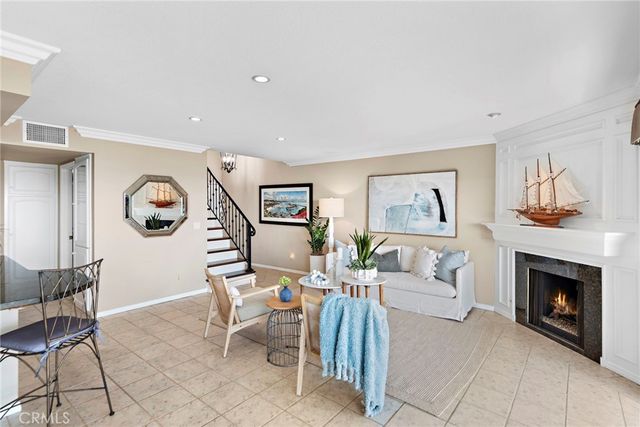 a living room with furniture a fireplace and a table