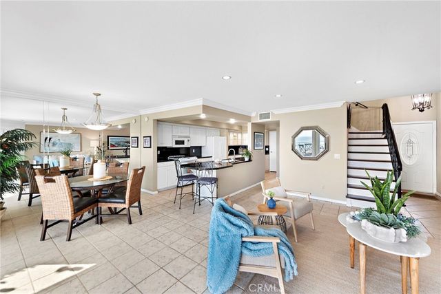 a large white kitchen with stainless steel appliances granite countertop a stove and a sink