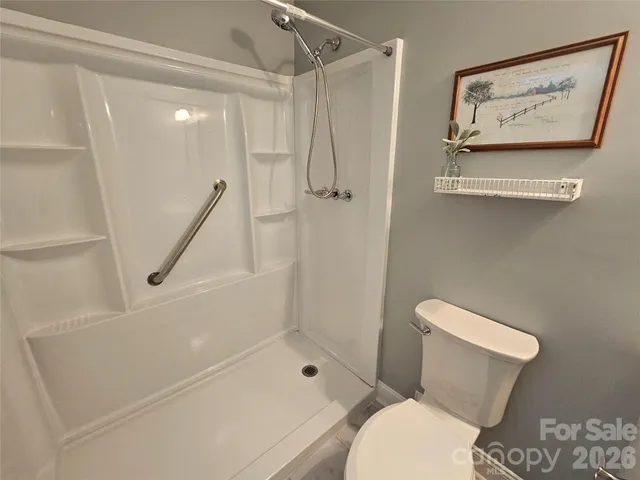 a bathroom with a shower and toilet