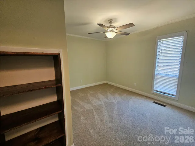 a view of room with window and ceiling fan