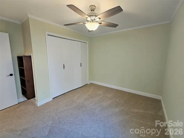 an empty room with fan and a ceiling fan