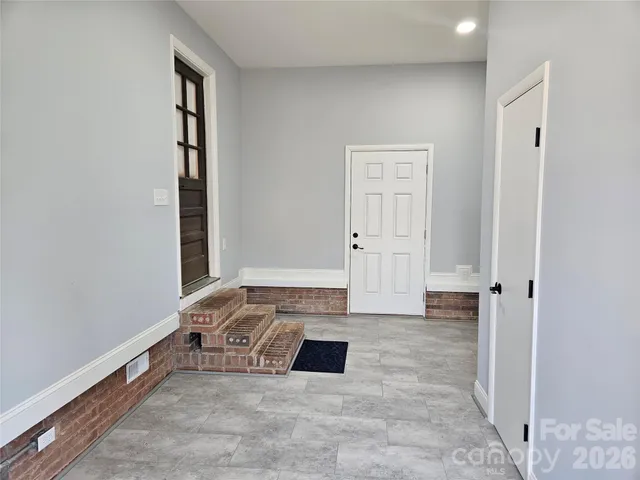 a backyard of a house with large trees and outdoor space