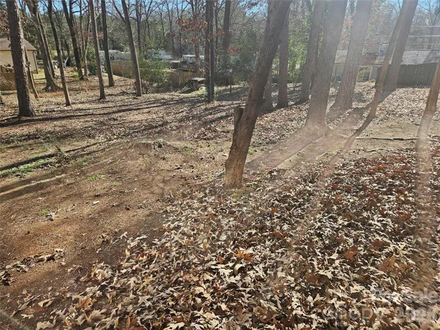 a backyard of a house with barbeque oven table and chairs