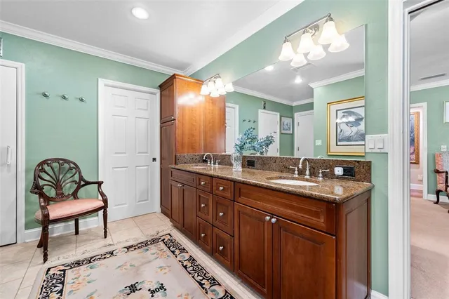 a spacious bathroom with a granite countertop sink a mirror and a bathtub