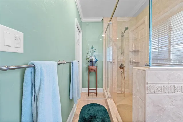 a bathroom with a granite countertop shower and a mirror