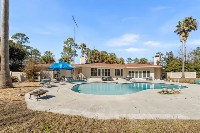 a front view of a house with a yard and lake view