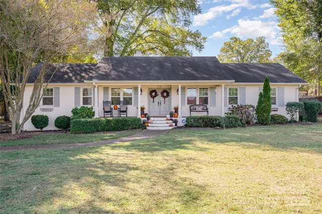 a view of a house with swimming pool and a porch