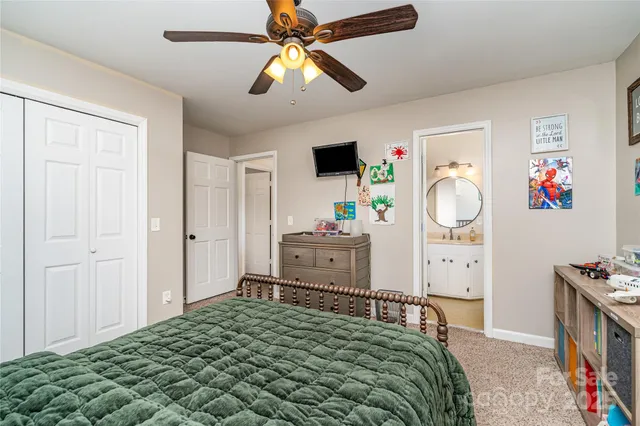 a bedroom with a bed and a tv