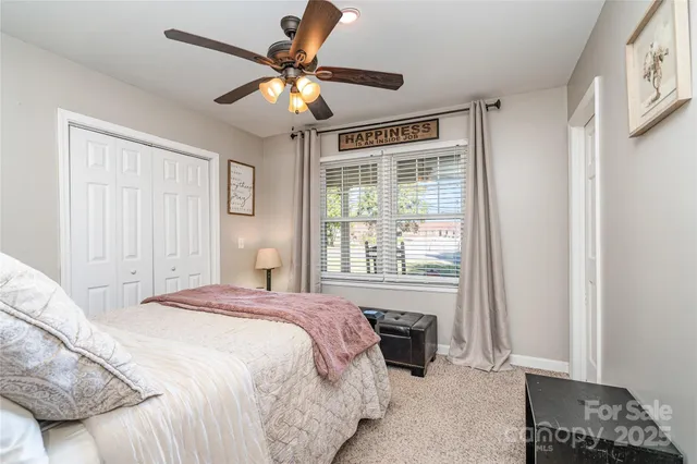 a spacious bedroom with a bed and a window