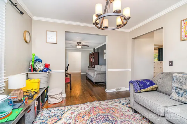 a living room with furniture and a chandelier