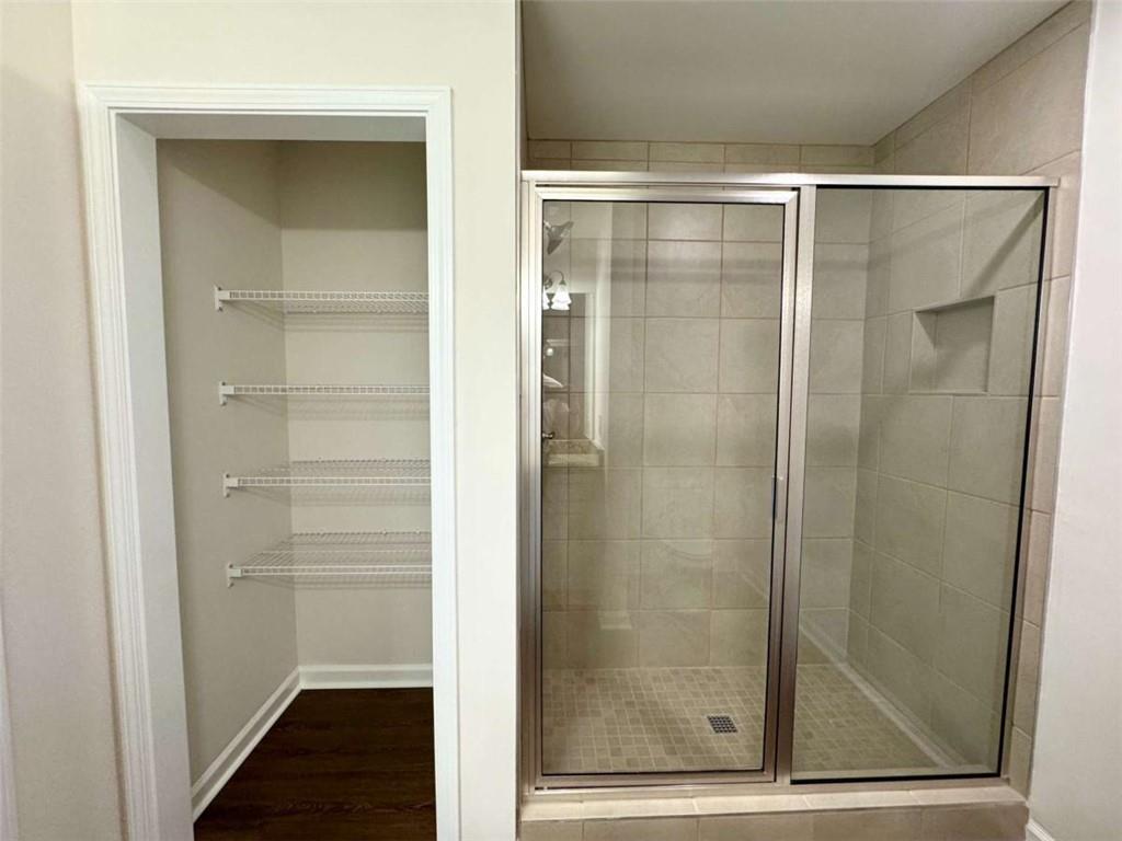 6326 Pine Ridge Point Lula, GA 30554 - Photo 15 of 23 a bathroom with a glass shower door