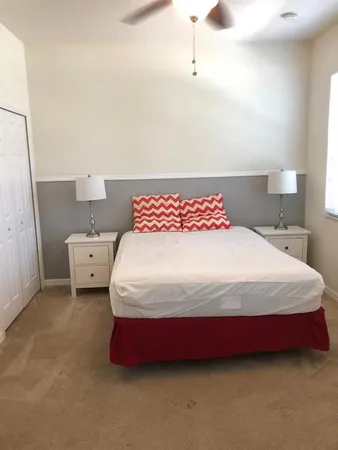 a bedroom with a bed and a night stand