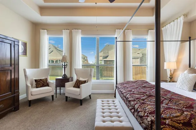 a spacious bedroom with a large bed and a couch