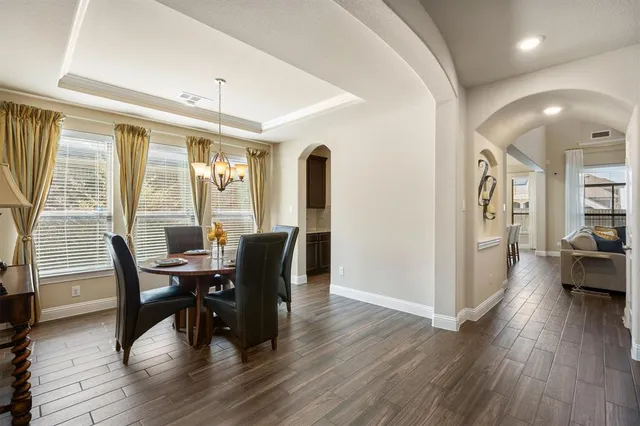 a view of a dining room with furniture and wooden floor