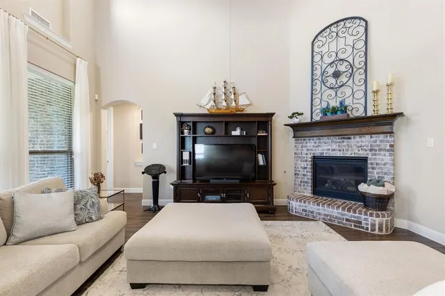 a living room with furniture a fireplace and a flat screen tv
