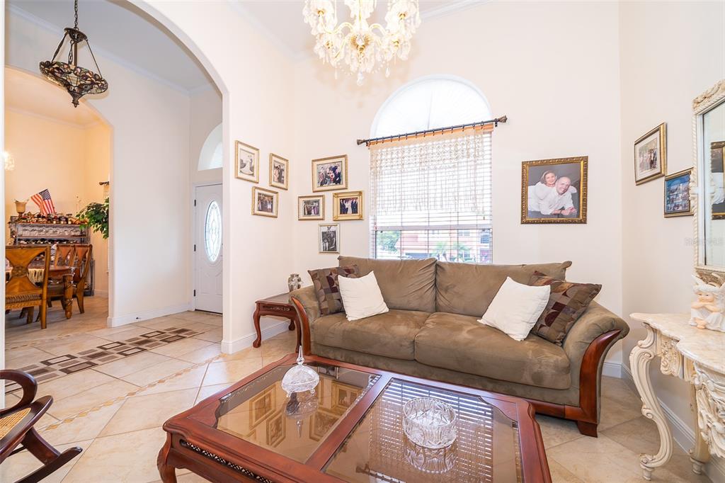 1607 Oak Hollow Road Clermont, FL 34711 - Photo 15 of 30 a living room with furniture and a chandelier