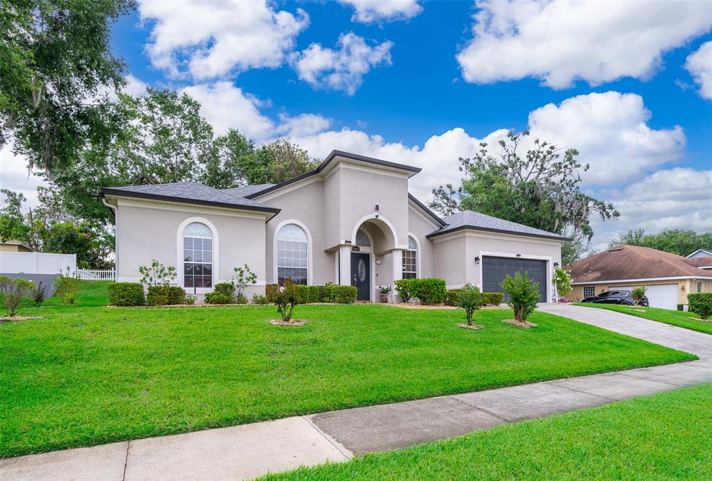 1607 Oak Hollow Road Clermont, FL 34711 - Photo 24 of 30 a front view of a house with a garden