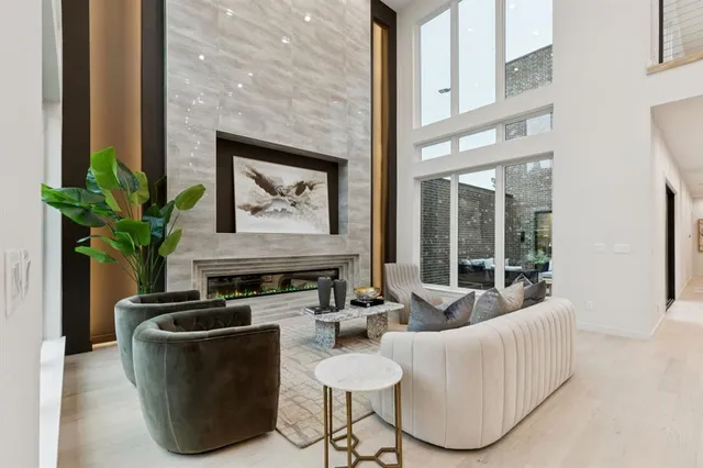 a living room with furniture a potted plant and a fireplace