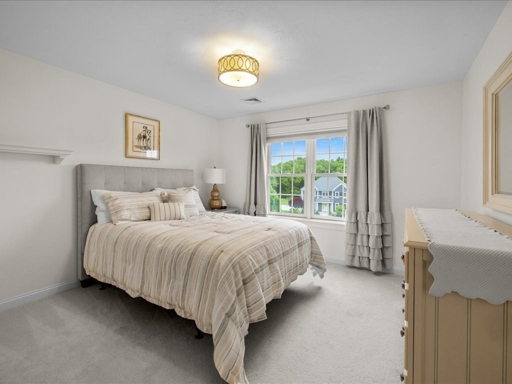 10 Beech Street Millis, MA 02054 - Photo 21 of 40 a spacious bedroom with a bed and a window