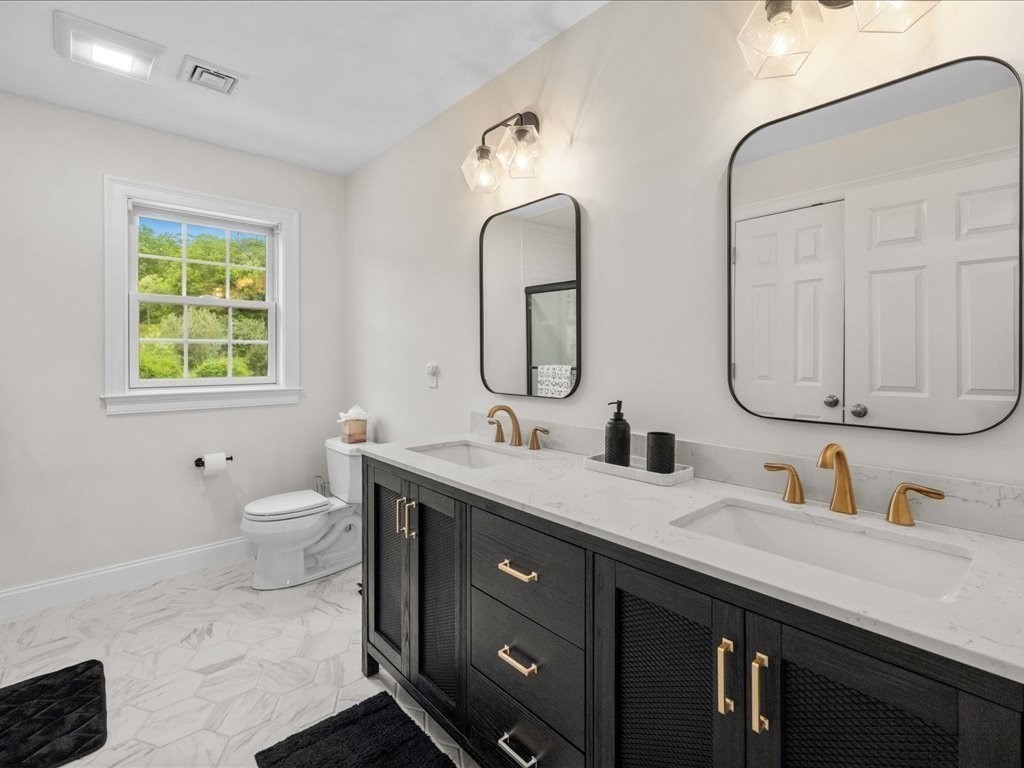 10 Beech Street Millis, MA 02054 - Photo 22 of 40 a bathroom with a double vanity sink and a mirror