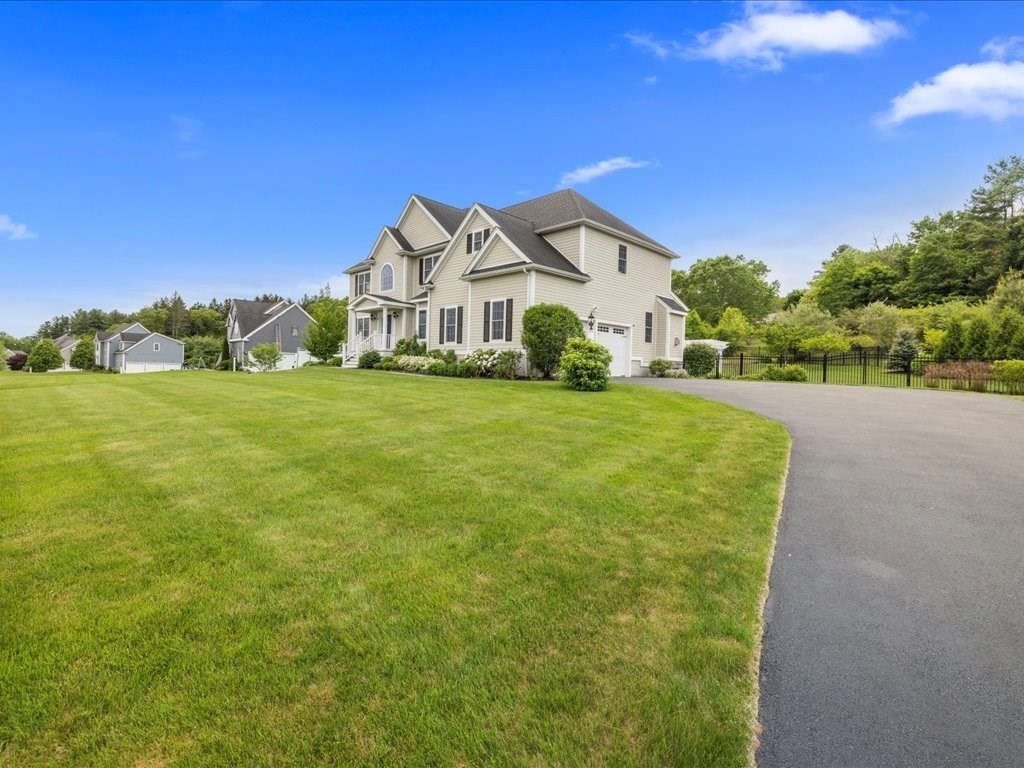 10 Beech Street Millis, MA 02054 - Photo 3 of 40 a front view of a house with a yard