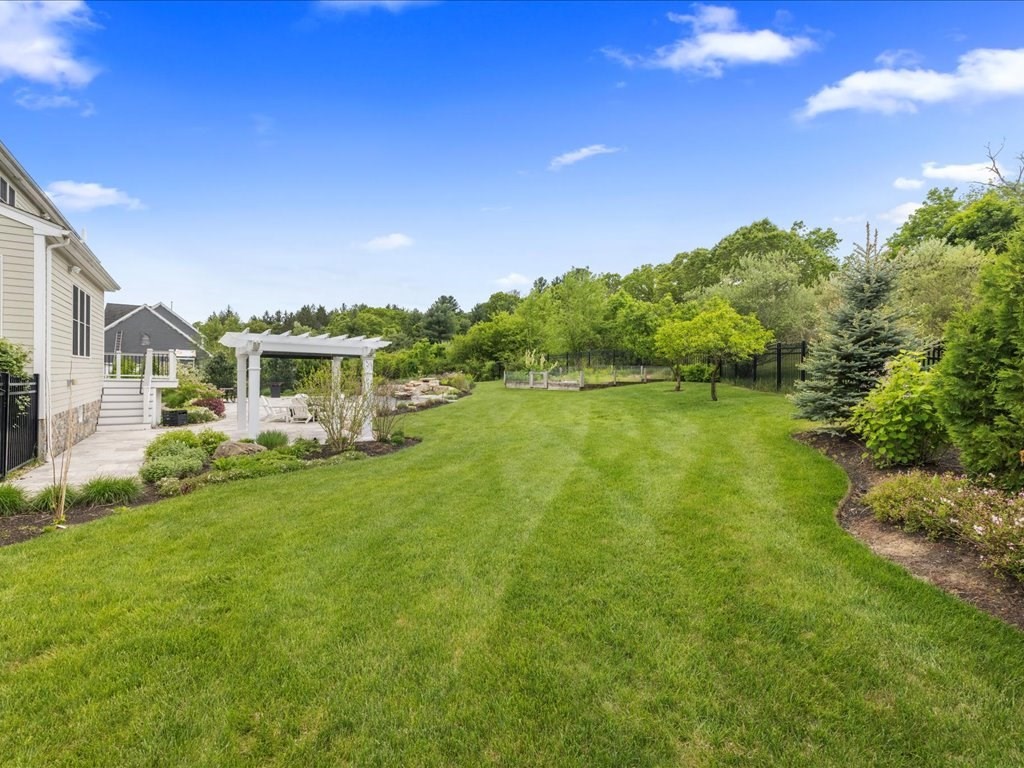 10 Beech Street Millis, MA 02054 - Photo 37 of 40 a view of a house with a yard and a garden