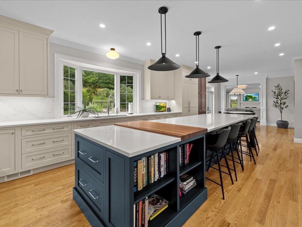10 Beech Street Millis, MA 02054 - Photo 4 of 40 a kitchen with stainless steel appliances kitchen island a large island in the center and wooden floor
