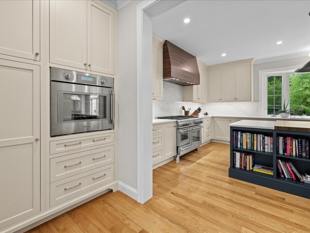 10 Beech Street Millis, MA 02054 - Photo 10 of 40 a kitchen with stainless steel appliances white cabinets and a wooden floor