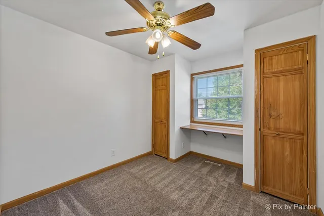 a view of workspace with window and ceiling fan